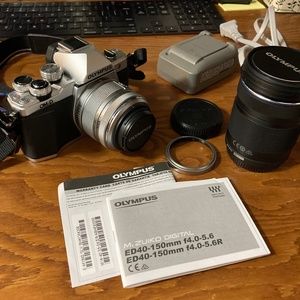 Olympus Mark II Mirrorless Camera with two lenses and bag